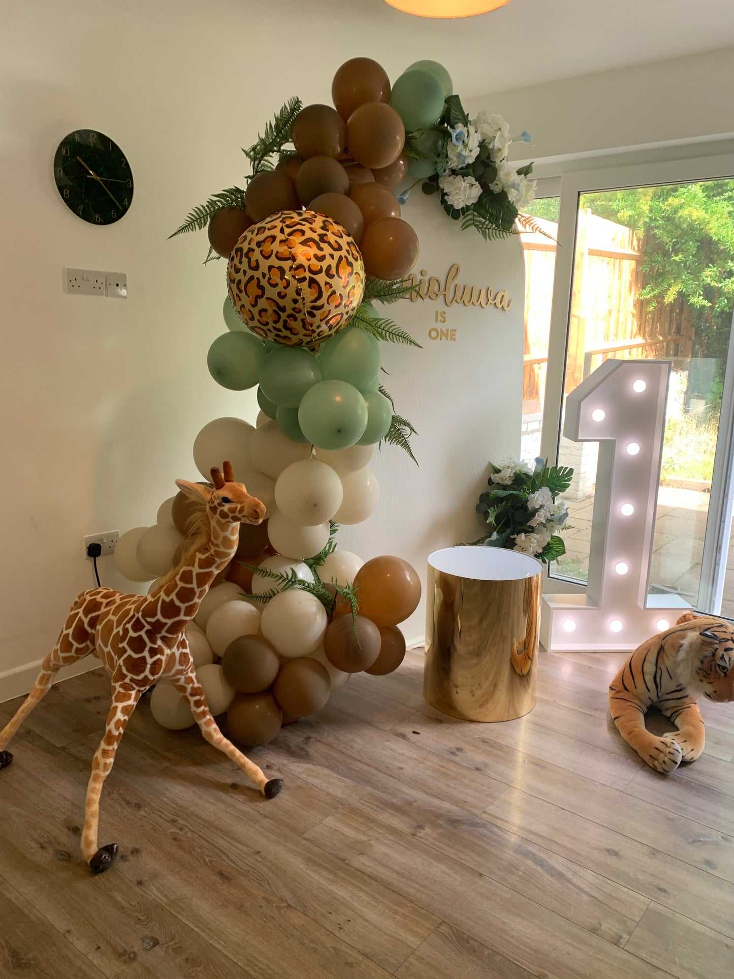 Safari theme Arch backdrop with balloon garland, plinth and number light